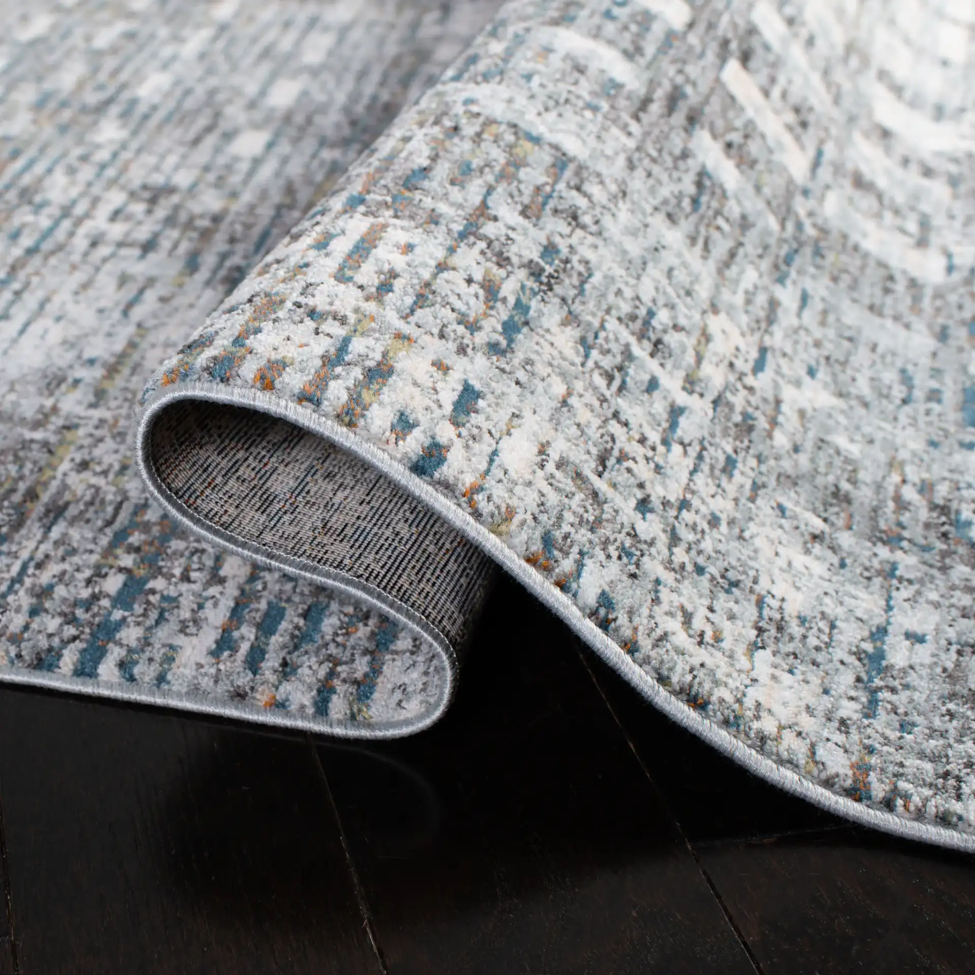 Winston Distressed Grid Rug in Gray / Beige in a styled room