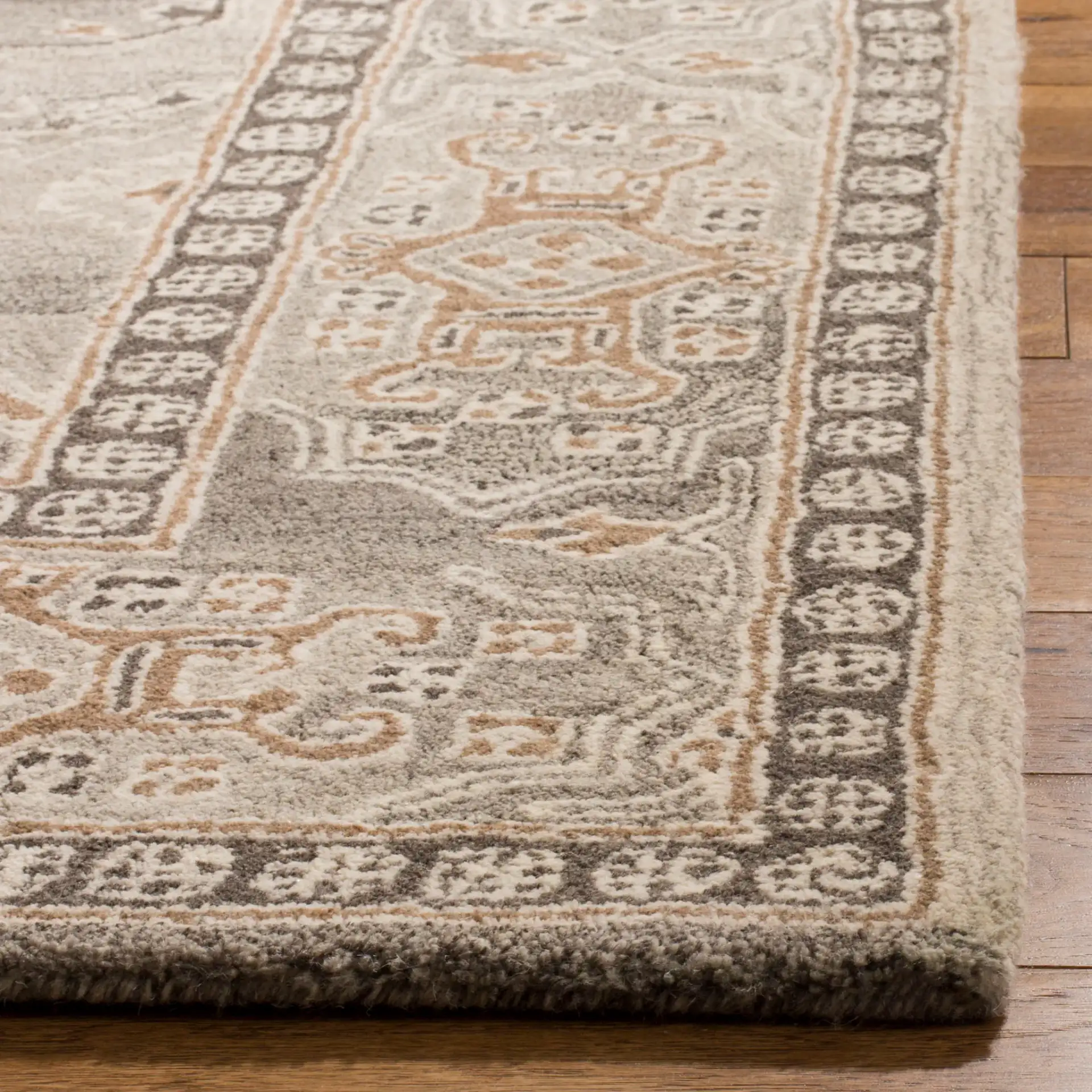 Wyndham Medallion Bordered Hand-Tufted Wool Rug in Light Gray in a styled room