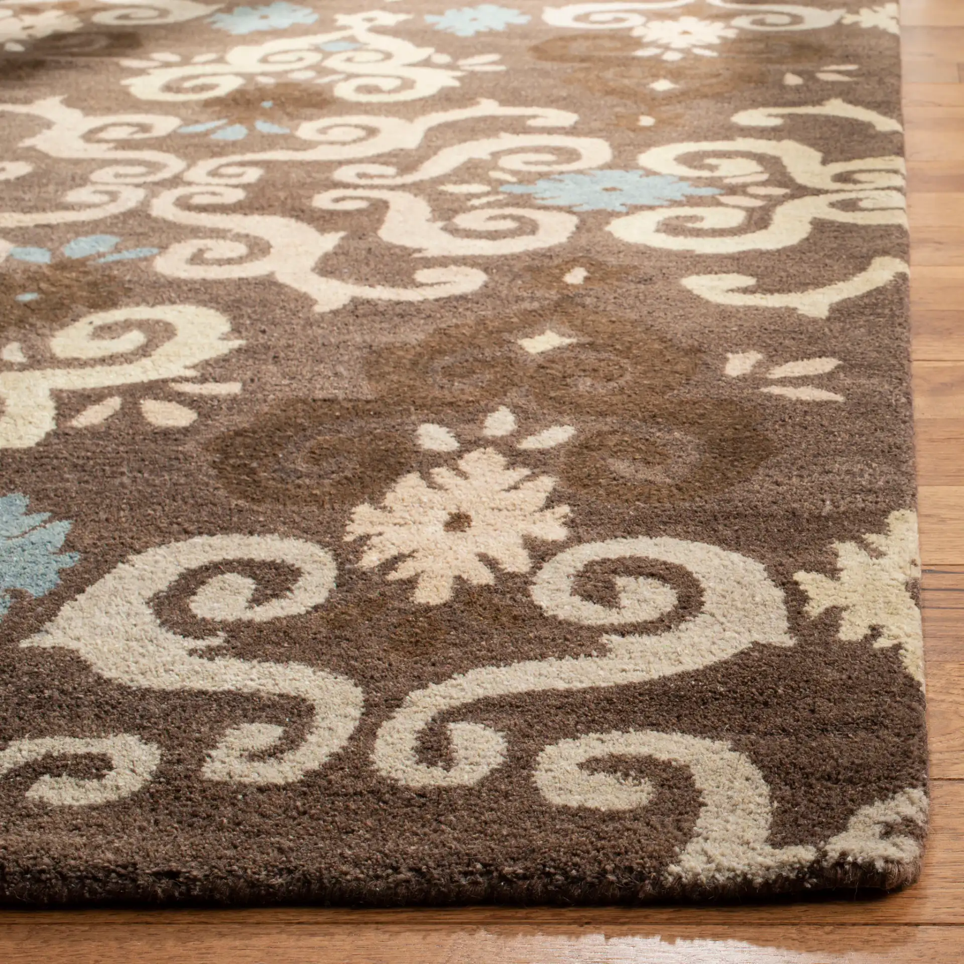 Wyndham Scrolling Damask Hand-Tufted Wool Rug in Brown / Multicolor in a styled room