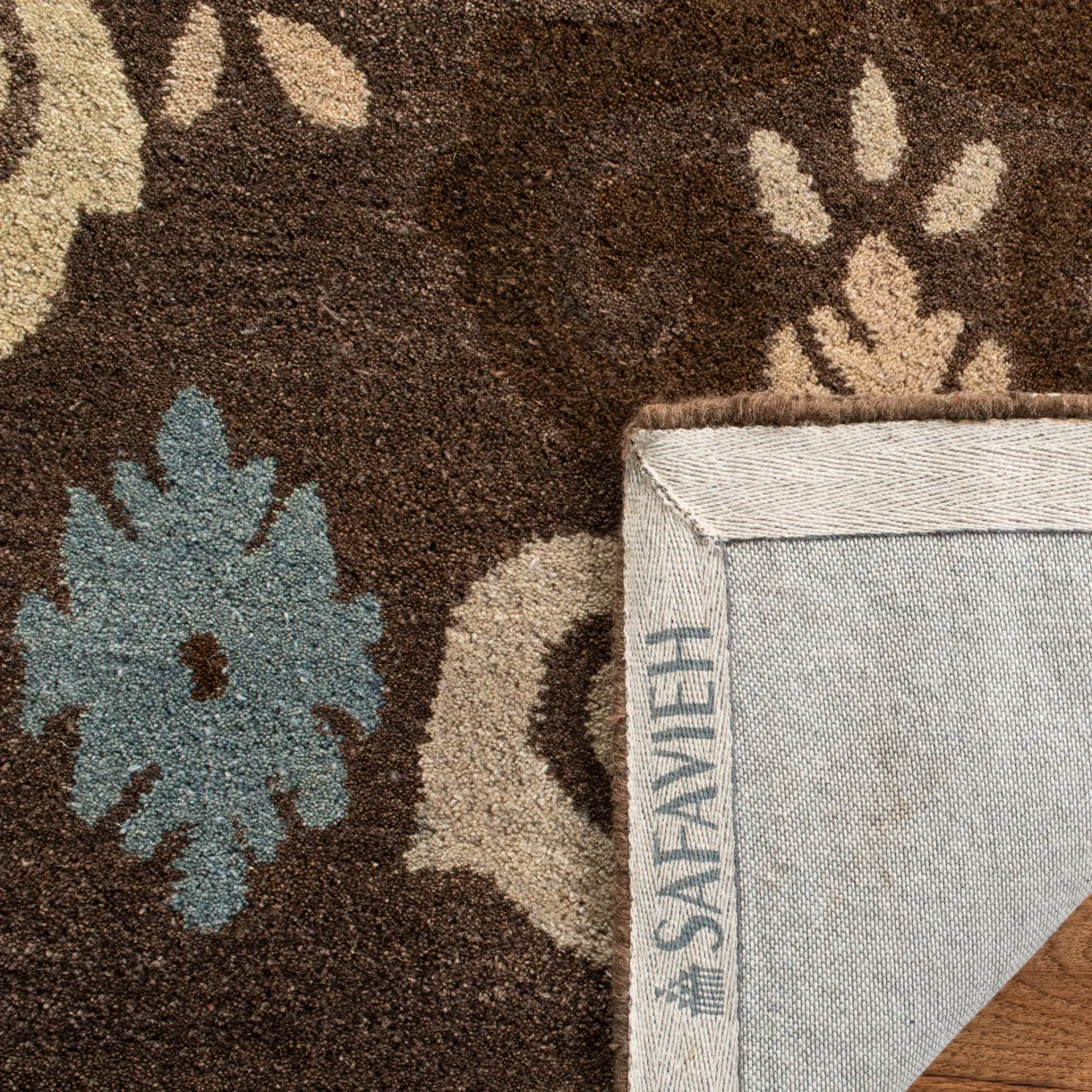 Wyndham Scrolling Damask Hand-Tufted Wool Rug in Brown / Multicolor in a styled room
