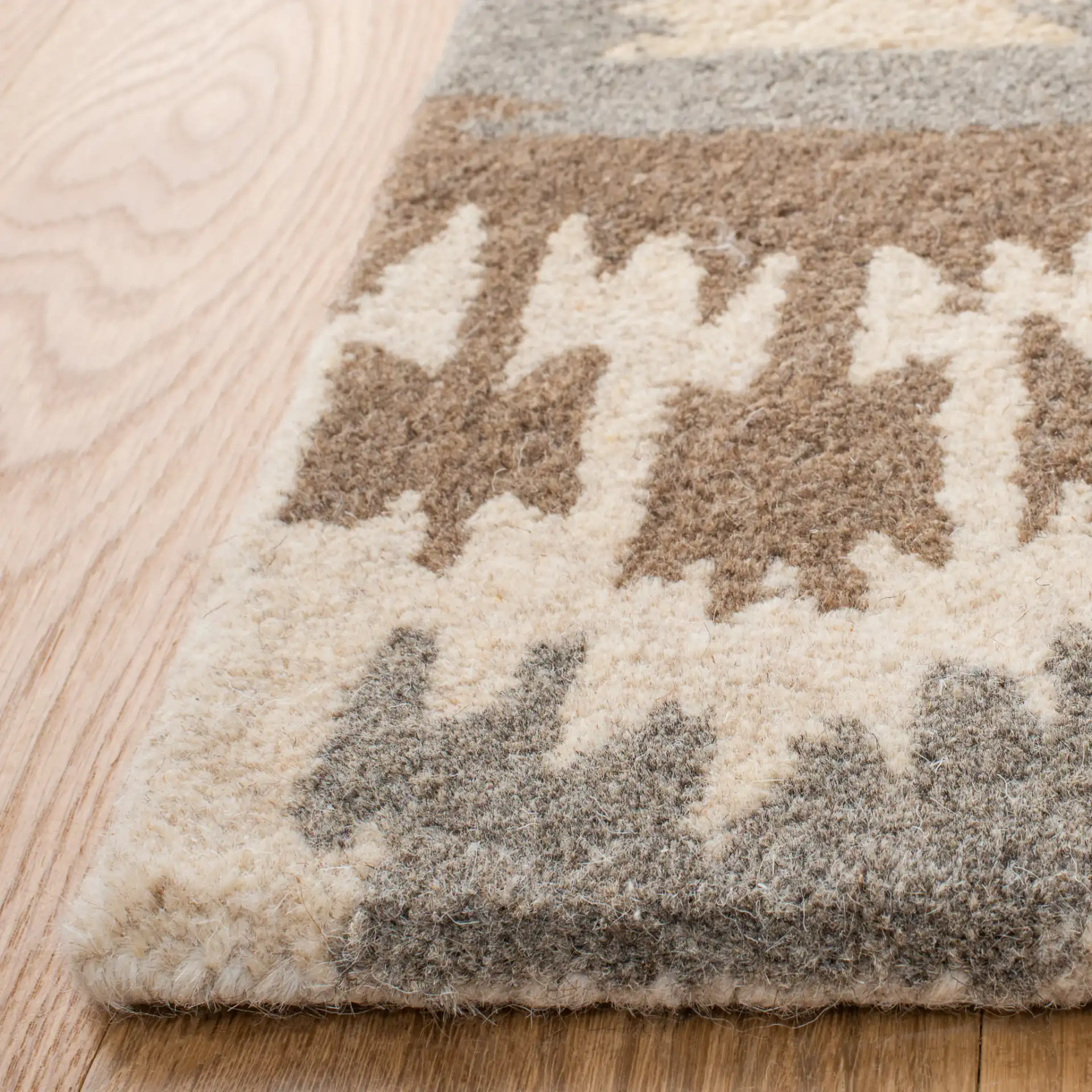 Wyndham Ikat Diamond Hand-Tufted Wool Rug in Natural / Multicolor in a styled room