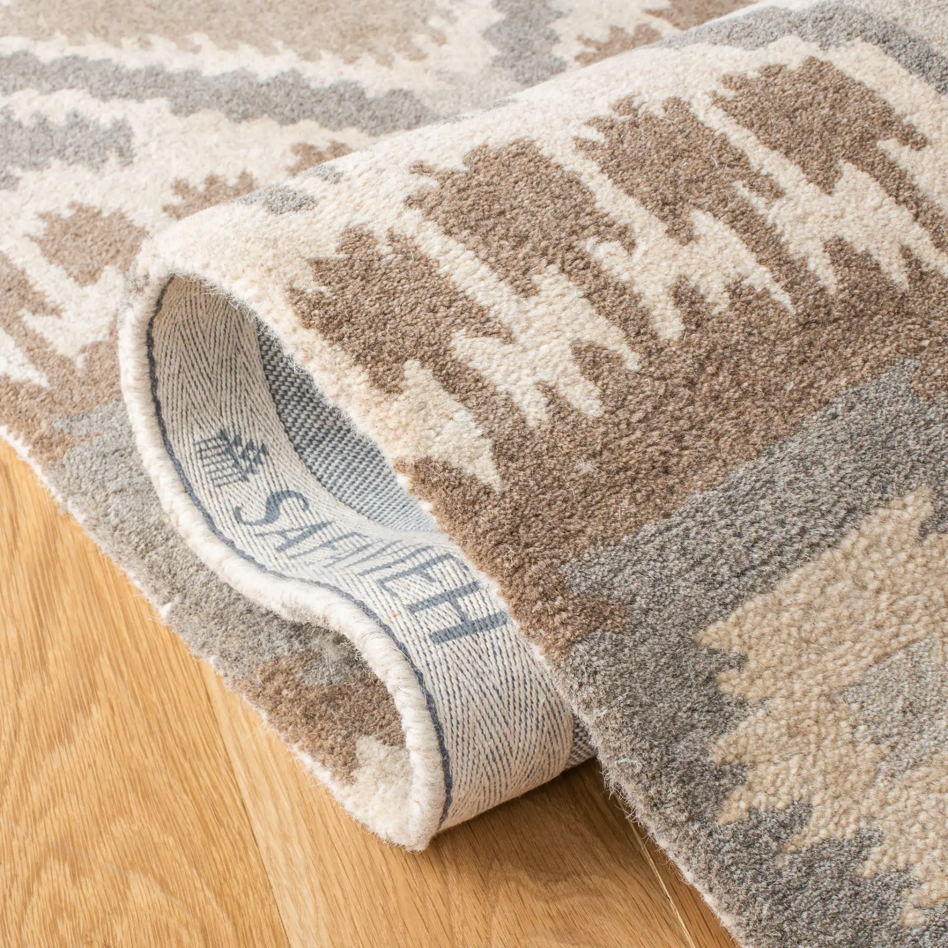 Wyndham Ikat Diamond Hand-Tufted Wool Rug in Natural / Multicolor in a styled room